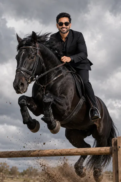 Man in Black Suit Riding a Black Horse Mid-Air Jump